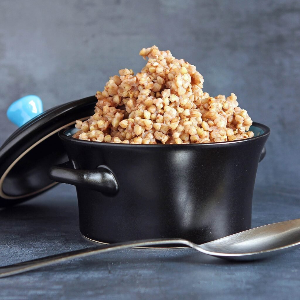 Cooked buckwheat in a black pot